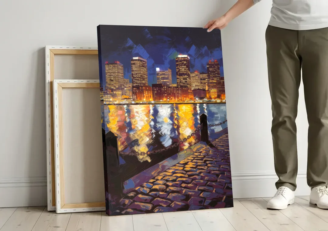 Boston Downtown Night Lights canvas wall art leaning against a wall next to blank canvases