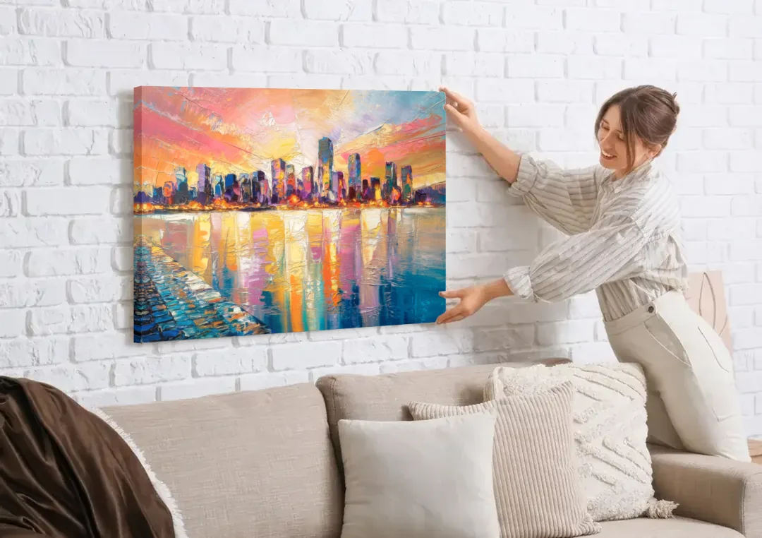 Boston Harbor Sunrise canvas wall art being hung on a white brick wall above a sofa