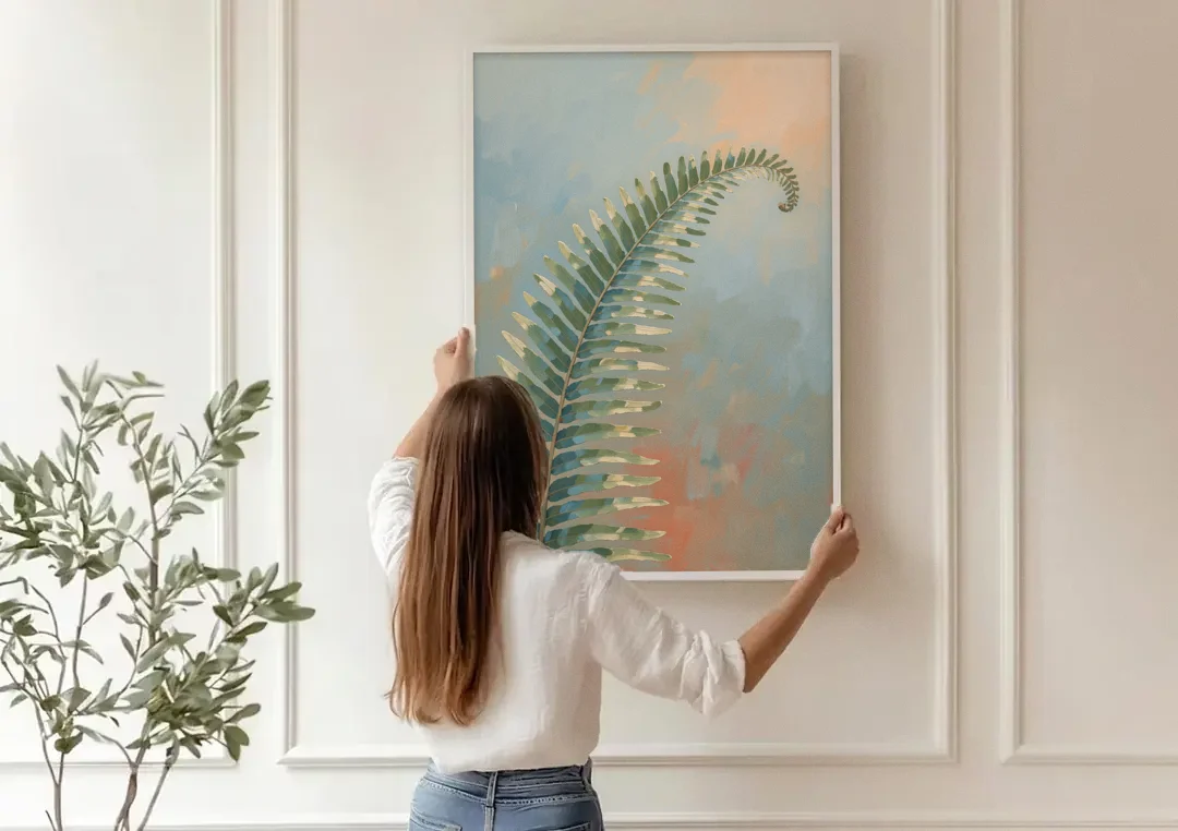 Botanical Arching Fern Frond in Early Light canvas wall art being hung on a paneled wall