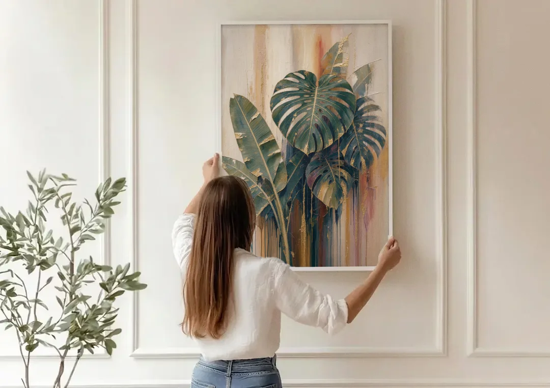 Botanical Gilded Monstera and Banana Leaves for the Bathroom canvas wall art being hung on a paneled wall