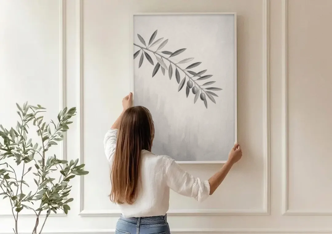 Botanical Paintings Olive Branch in Soft Grey canvas wall art being hung on a paneled wall