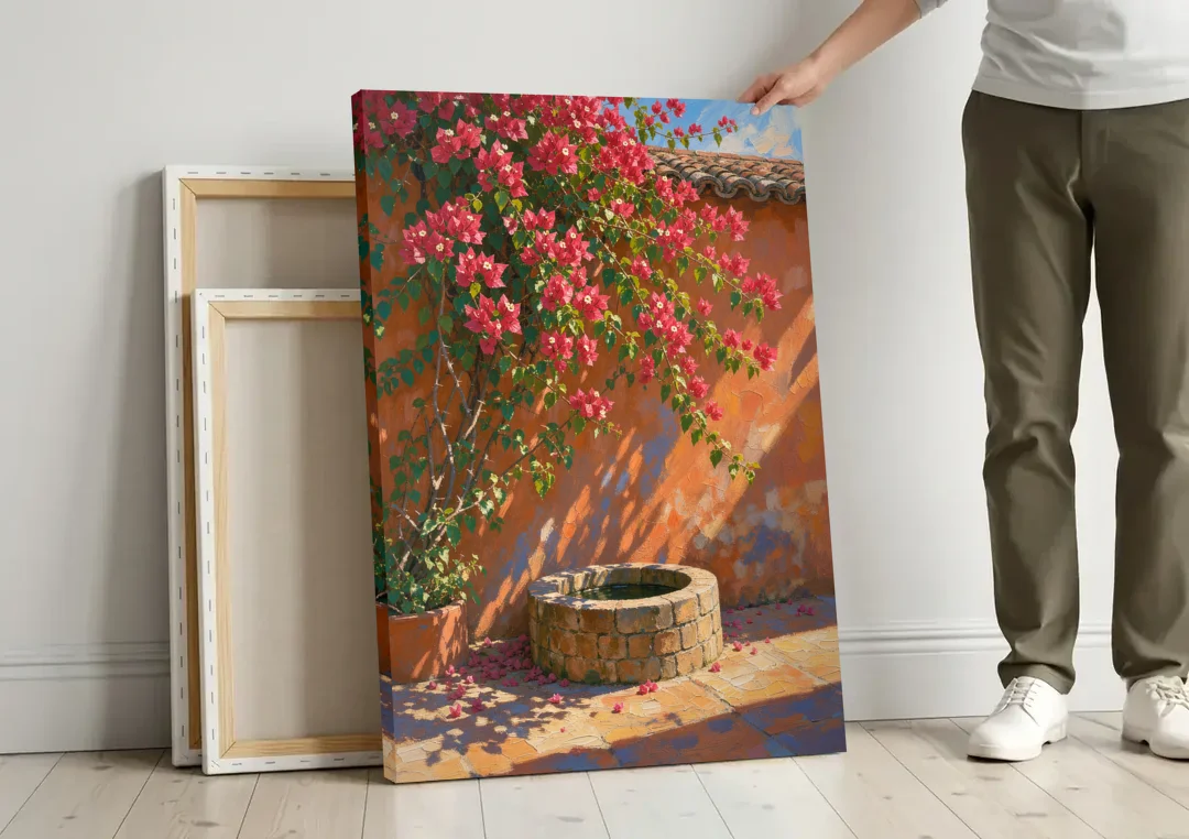 Bougainvillea Wall Art Over a Courtyard Well canvas wall art leaning against a wall next to blank canvases