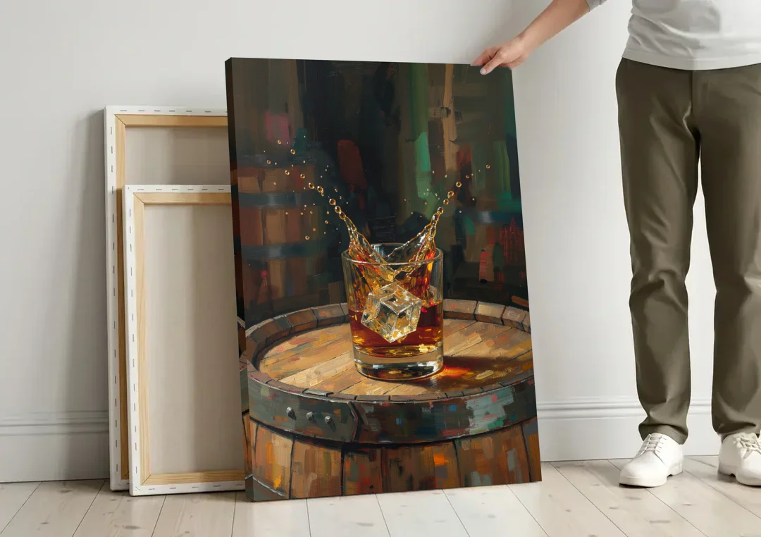 Bourbon Painting with an Ice Cube Splash canvas wall art leaning against a wall next to blank canvases