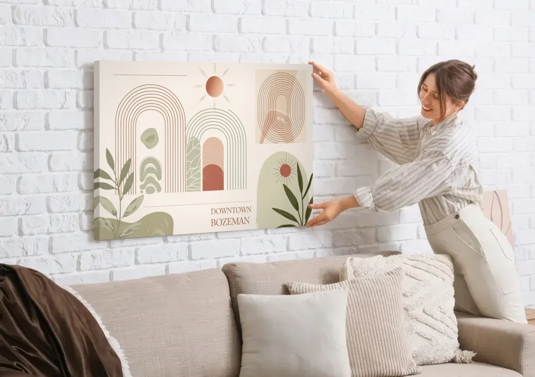 Bozeman Downtown Charm canvas wall art being hung on a white brick wall above a sofa