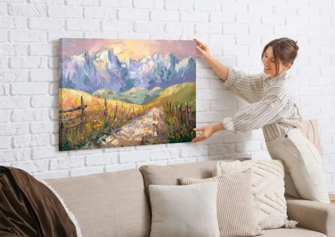 Bozeman Mountain Views canvas wall art being hung on a white brick wall above a sofa