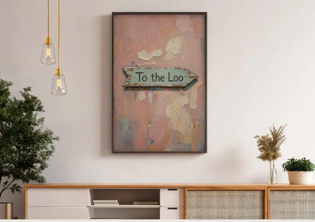 British Bathroom Decor with a Weathered Loo Arrow canvas wall art above a wooden sideboard under pendant lights