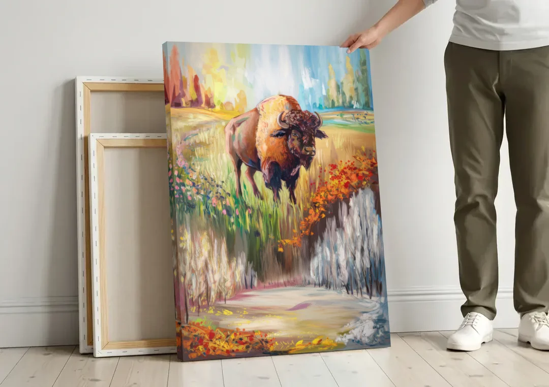 Buffalo All Seasons Beauty canvas wall art leaning against a wall next to blank canvases