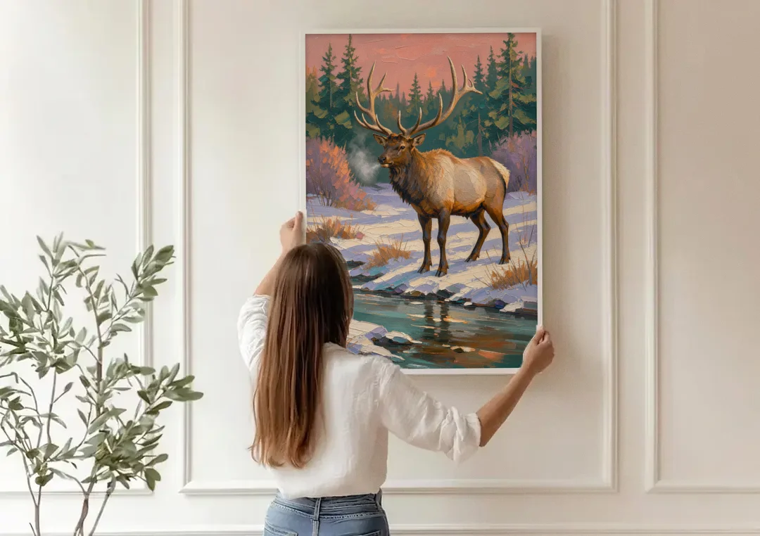 Bull Elk at the Snowy Creek in Winter canvas wall art being hung on a paneled wall