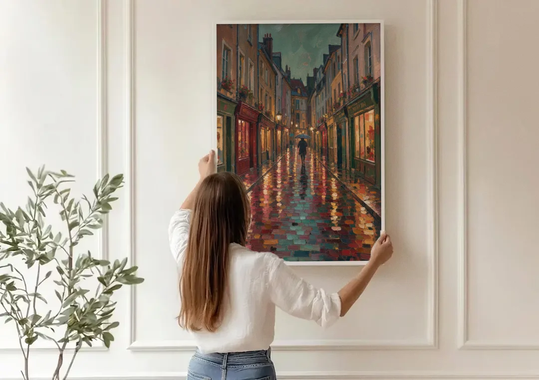 Burgundy Wall Decor of a Rainy Cobblestone Lane canvas wall art being hung on a paneled wall