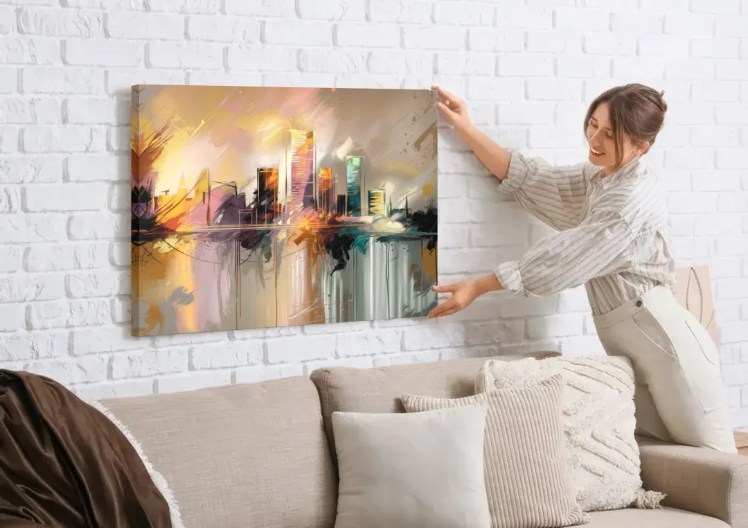 Burlington Artistic Cityscape canvas wall art being hung on a white brick wall above a sofa