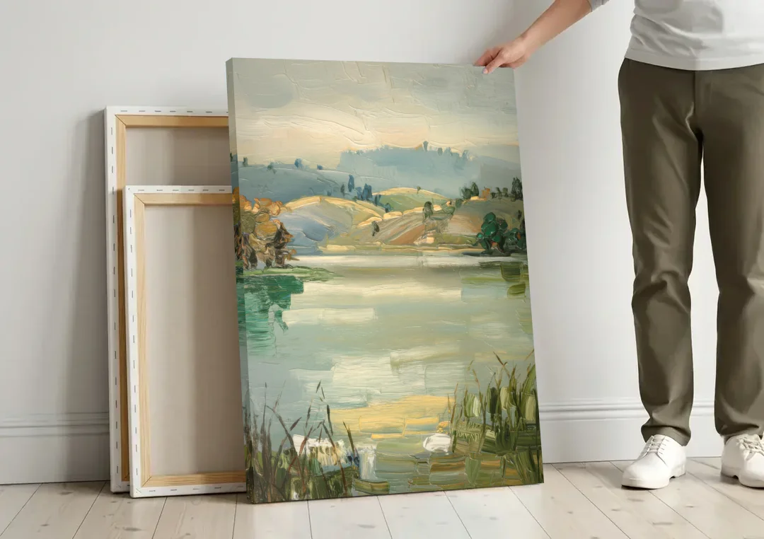 Burlington Peaceful Lakeside canvas wall art leaning against a wall next to blank canvases