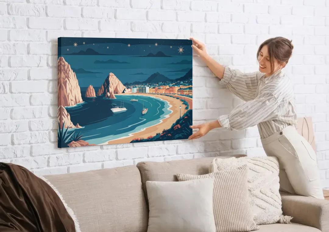 Cabo San Lucas Night Skyline canvas wall art being hung on a white brick wall above a sofa