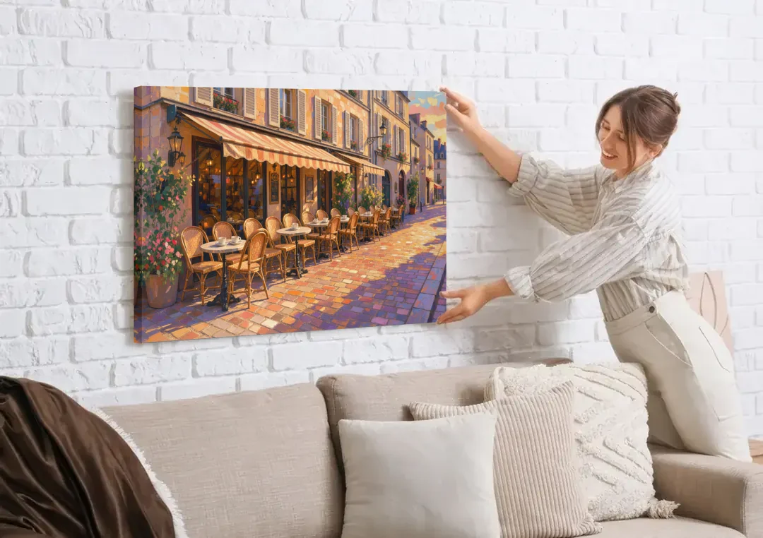 Cafe Painting of a Golden Hour Terrace canvas wall art being hung on a white brick wall above a sofa