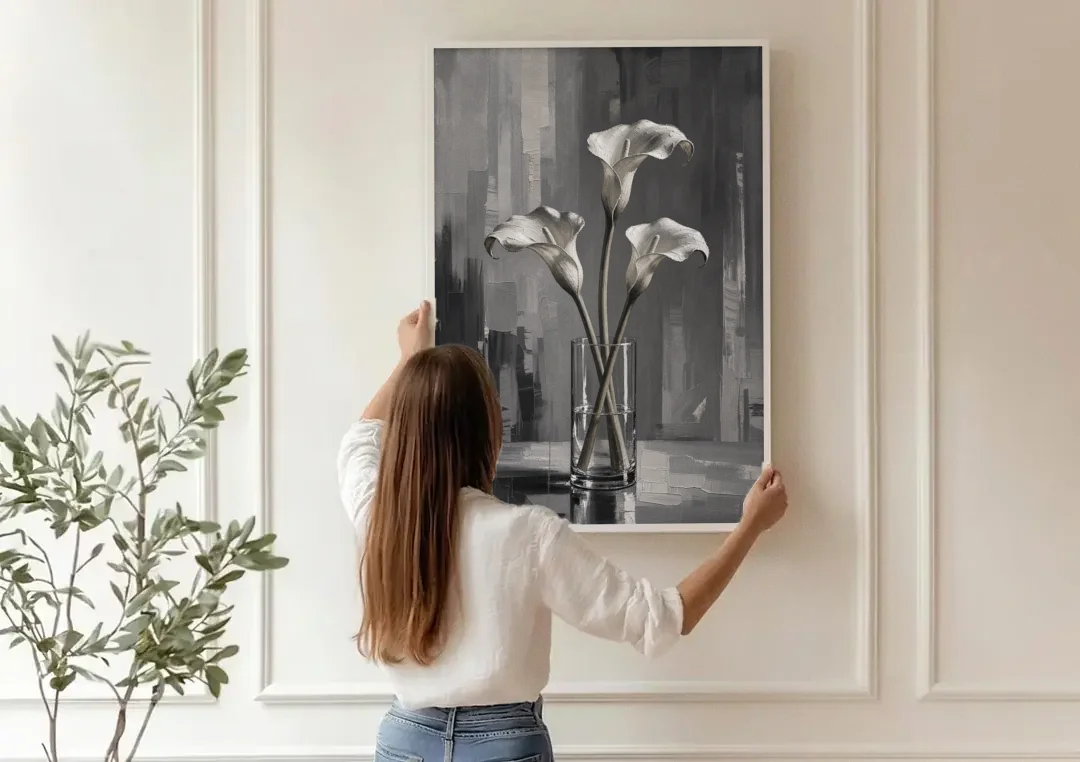 Calla Lily Wall Art with Three Stems in Glass canvas wall art being hung on a paneled wall