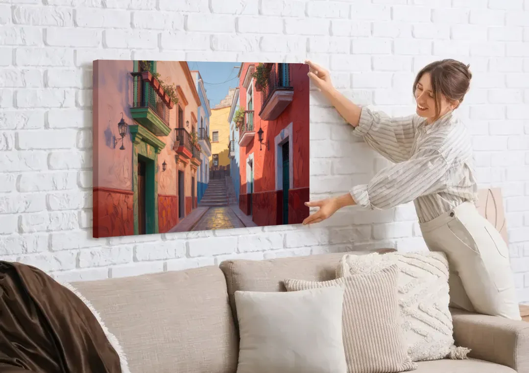 Callejón del Beso Alley canvas wall art being hung on a white brick wall above a sofa