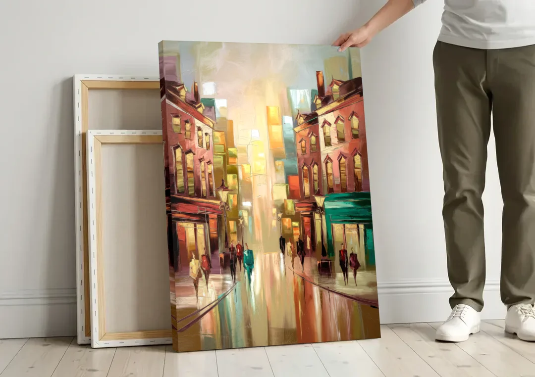 Camden Downtown Streetscape canvas wall art leaning against a wall next to blank canvases