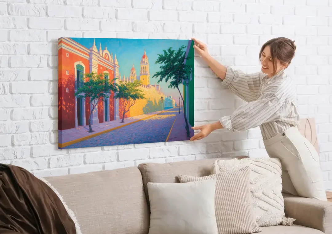 Campeche Walled City canvas wall art being hung on a white brick wall above a sofa