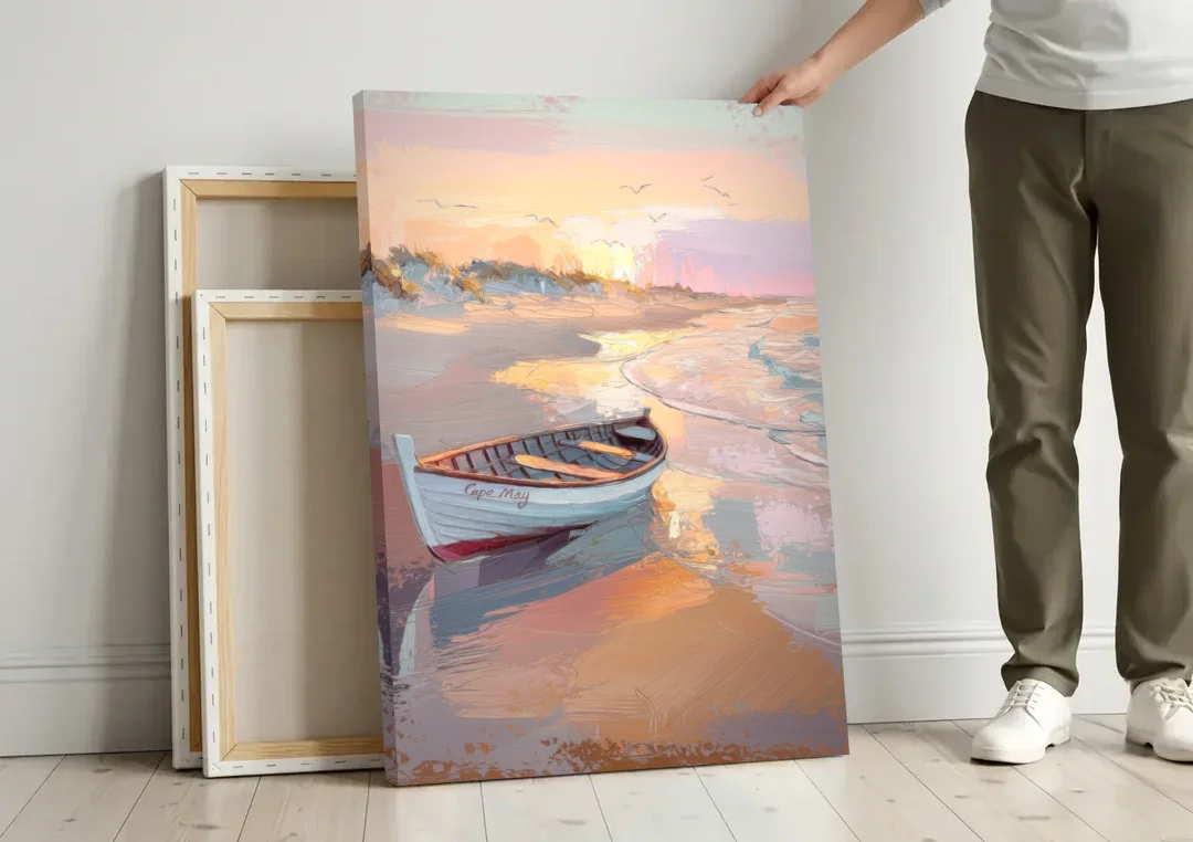 Cape May Beach Sunrise canvas wall art leaning against a wall next to blank canvases