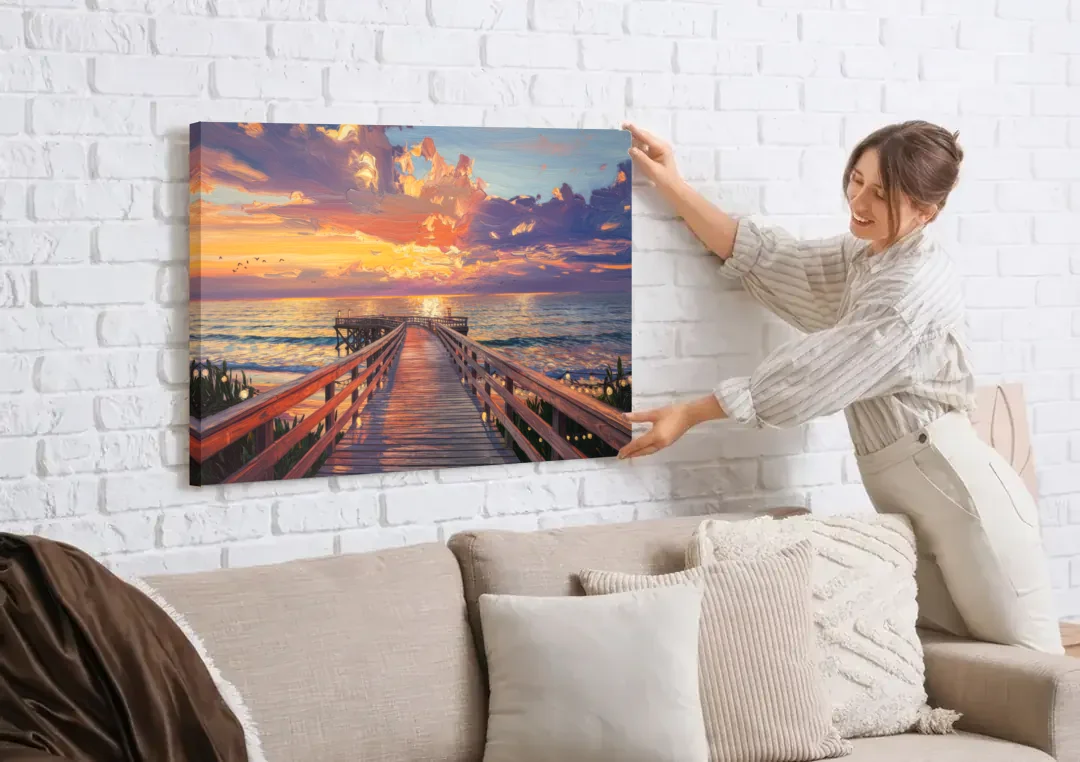 Cape May Sunset Pier canvas wall art being hung on a white brick wall above a sofa