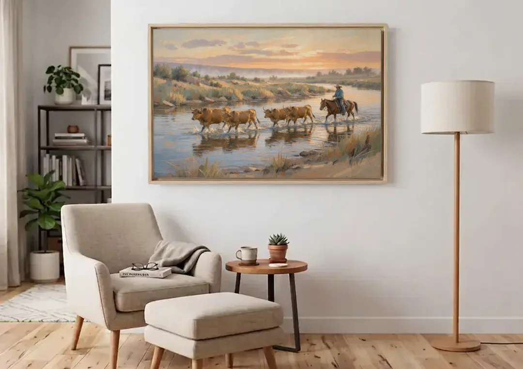 Cattle Drive Painting at the River Ford canvas wall art above an armchair in a bright living room
