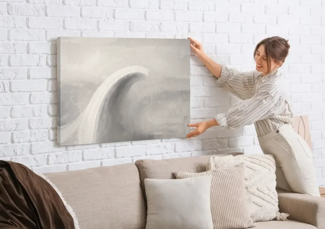 Abstract Chalk White Arc in Gray Mist for the Living Room canvas wall art being hung on a white brick wall above a sofa