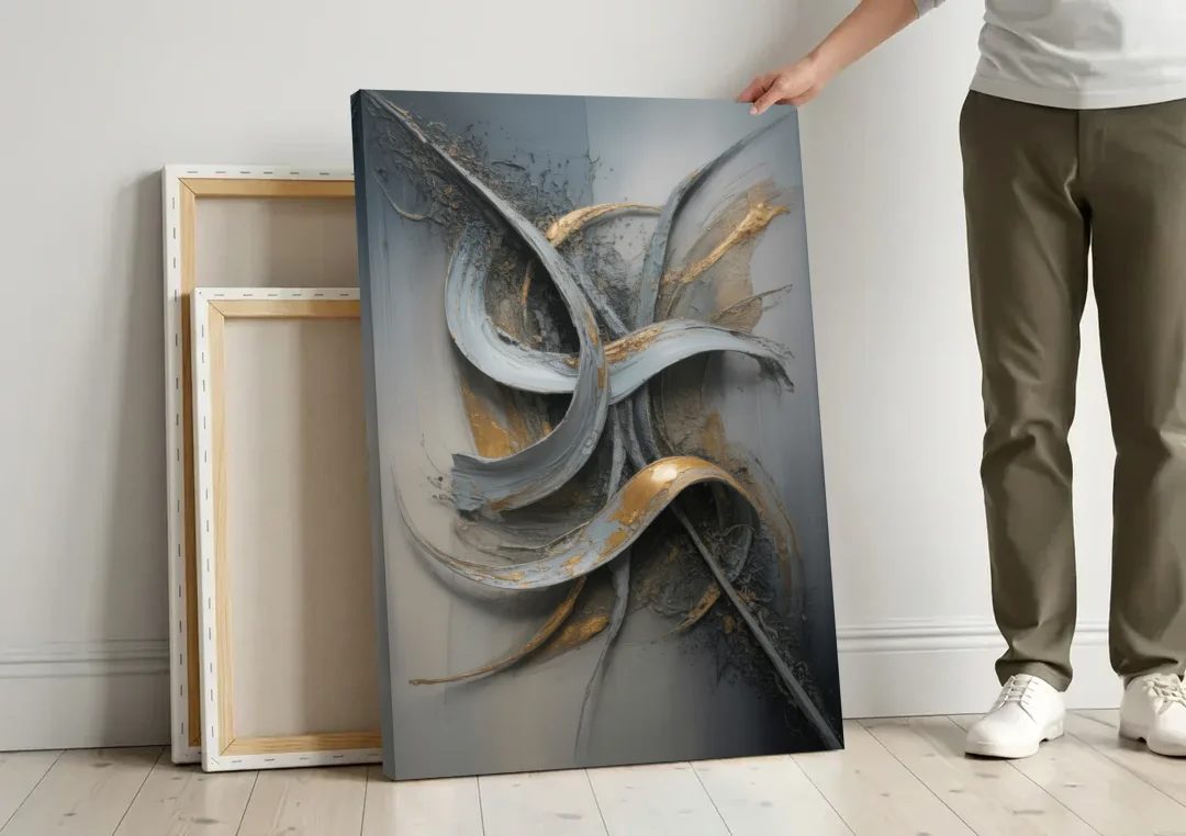 Chaotic Harmony Grey and Silver Abstract canvas wall art leaning against a wall next to blank canvases