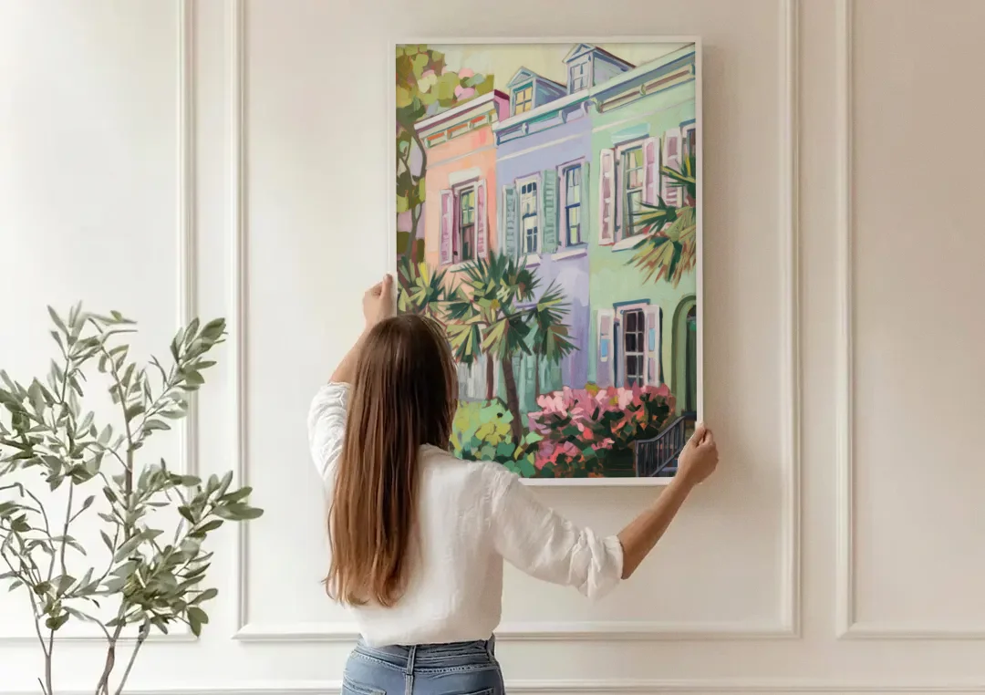 Charleston Rainbow Row canvas wall art being hung on a paneled wall