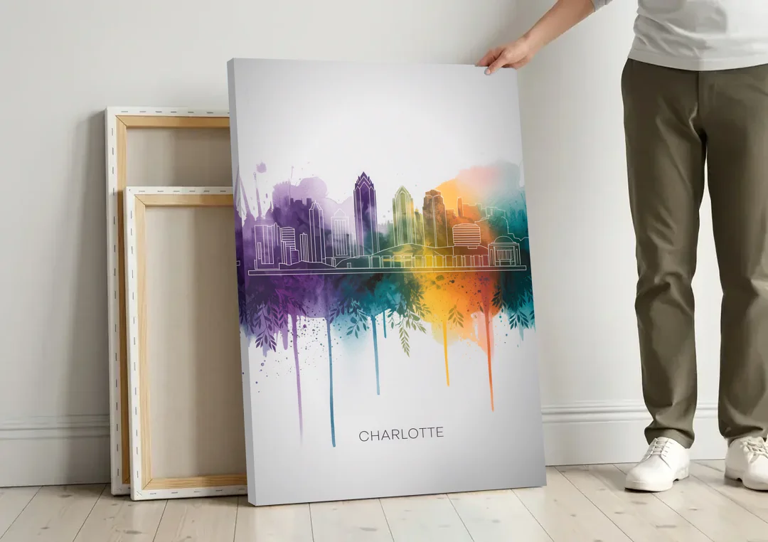 Charlotte Cityscape in Watercolor canvas wall art leaning against a wall next to blank canvases