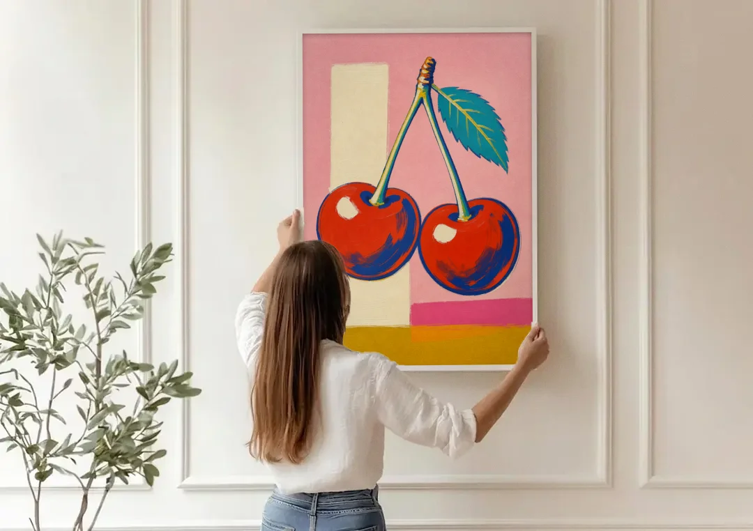 Cherries Painting with a Teal Leaf canvas wall art being hung on a paneled wall