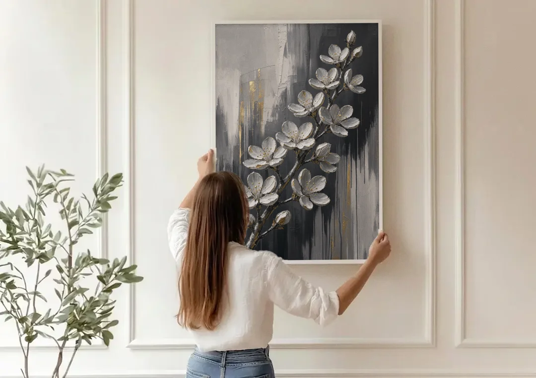 Cherry Blossom Branch Art in Charcoal and Gold canvas wall art being hung on a paneled wall