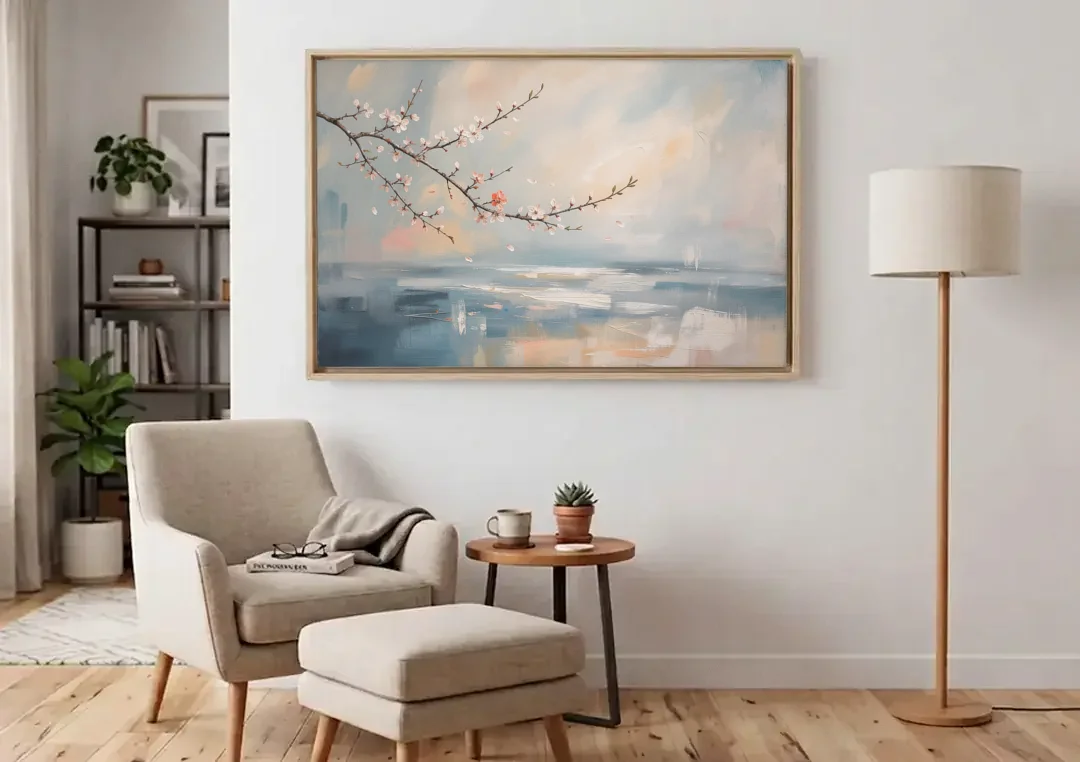 Abstract Cherry Blossom Branch Over Misty Sea canvas wall art above an armchair in a bright living room