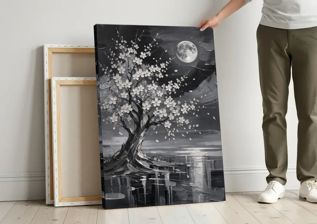 Cherry Blossom Night Painting Under Full Moon canvas wall art leaning against a wall next to blank canvases