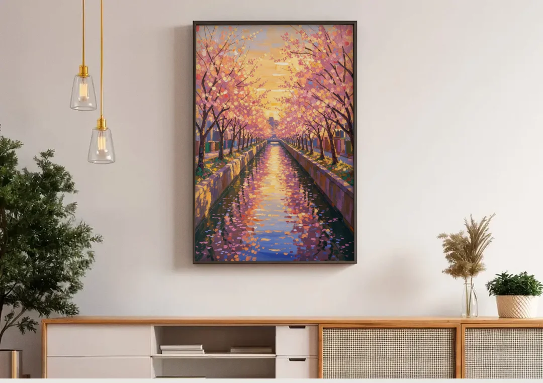 Cherry Blossom River Painting at Sunset canvas wall art above a wooden sideboard under pendant lights