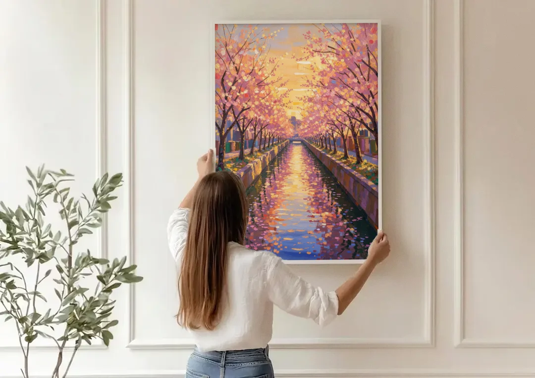 Cherry Blossom River Painting at Sunset canvas wall art being hung on a paneled wall