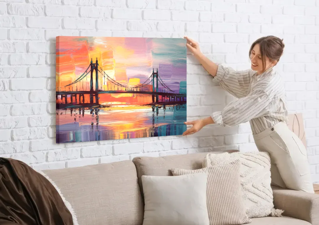 Chesapeake Bridge Silhouette canvas wall art being hung on a white brick wall above a sofa