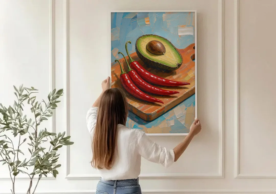 Chili Pepper Wall Art with Avocado on a Cutting Board canvas wall art being hung on a paneled wall