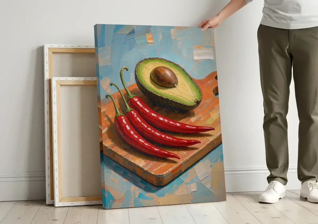 Chili Pepper Wall Art with Avocado on a Cutting Board canvas wall art leaning against a wall next to blank canvases