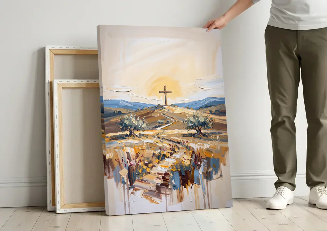 Christian Cross Landscape canvas wall art leaning against a wall next to blank canvases