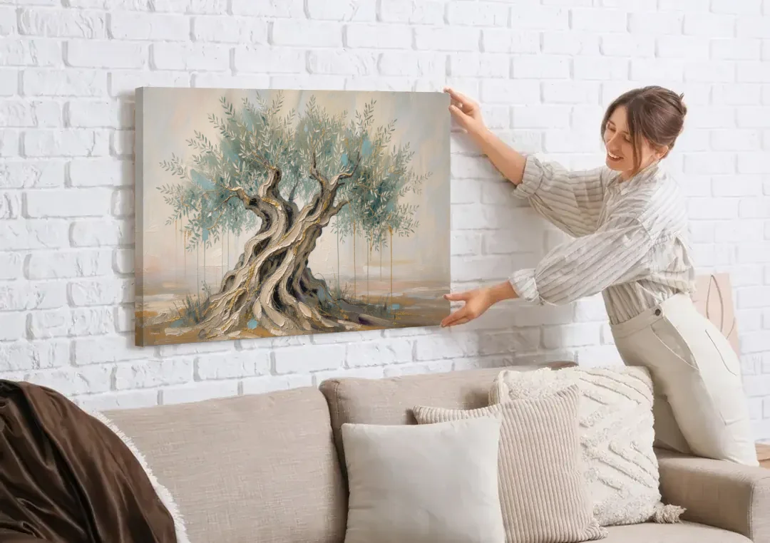 Christian Wall Decor with an Ancient Olive Tree canvas wall art being hung on a white brick wall above a sofa