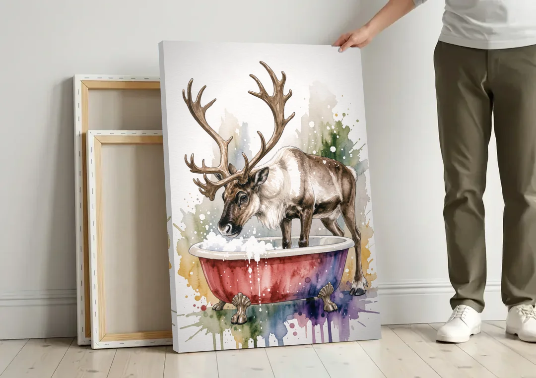 Christmas Bathroom Wall Art Reindeer Sniffing the Bubbles canvas wall art leaning against a wall next to blank canvases