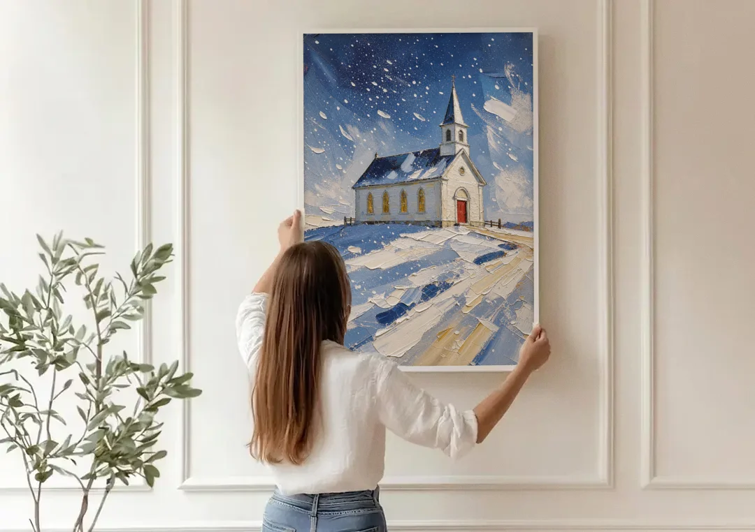 Christmas Eve Painting of a Hilltop Chapel canvas wall art being hung on a paneled wall