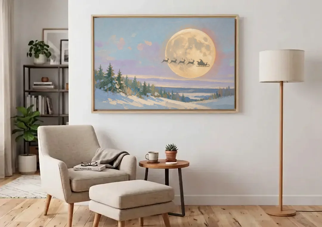 Christmas Moon Painting with Sleigh Silhouette canvas wall art above an armchair in a bright living room