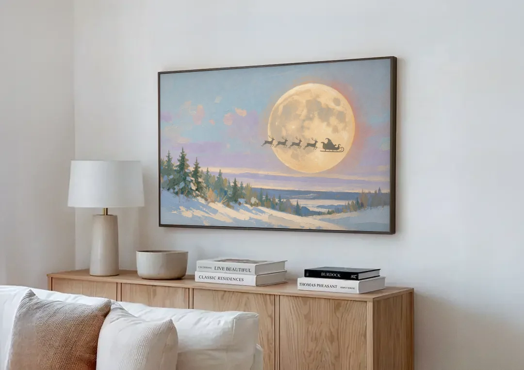 Christmas Moon Painting with Sleigh Silhouette canvas wall art above a wooden sideboard next to a sofa