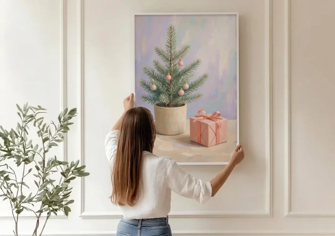 Christmas Tree Art Print with Pink Gift canvas wall art being hung on a paneled wall