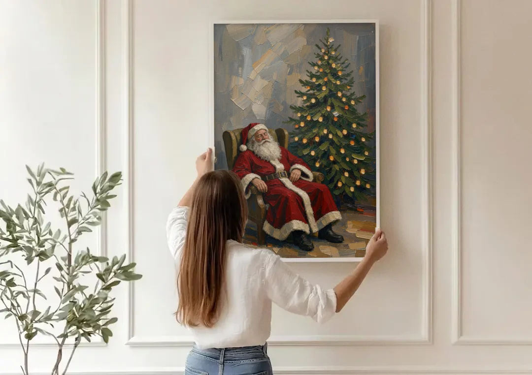 Christmas Tree Painting Canvas with Santa Asleep canvas wall art being hung on a paneled wall
