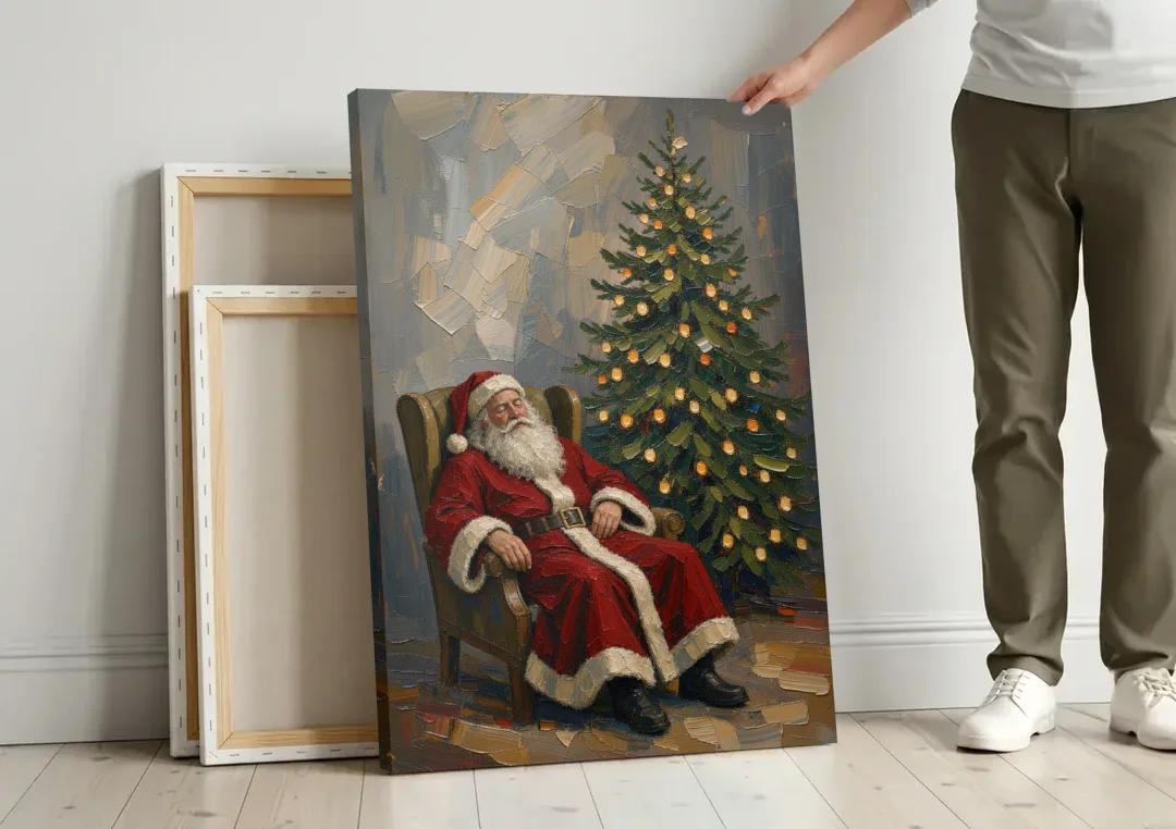 Christmas Tree Painting Canvas with Santa Asleep canvas wall art leaning against a wall next to blank canvases
