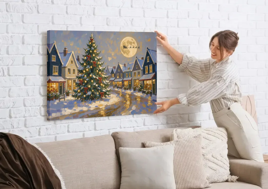 Christmas Village Wall Art with the Moonlit Tree Square canvas wall art being hung on a white brick wall above a sofa