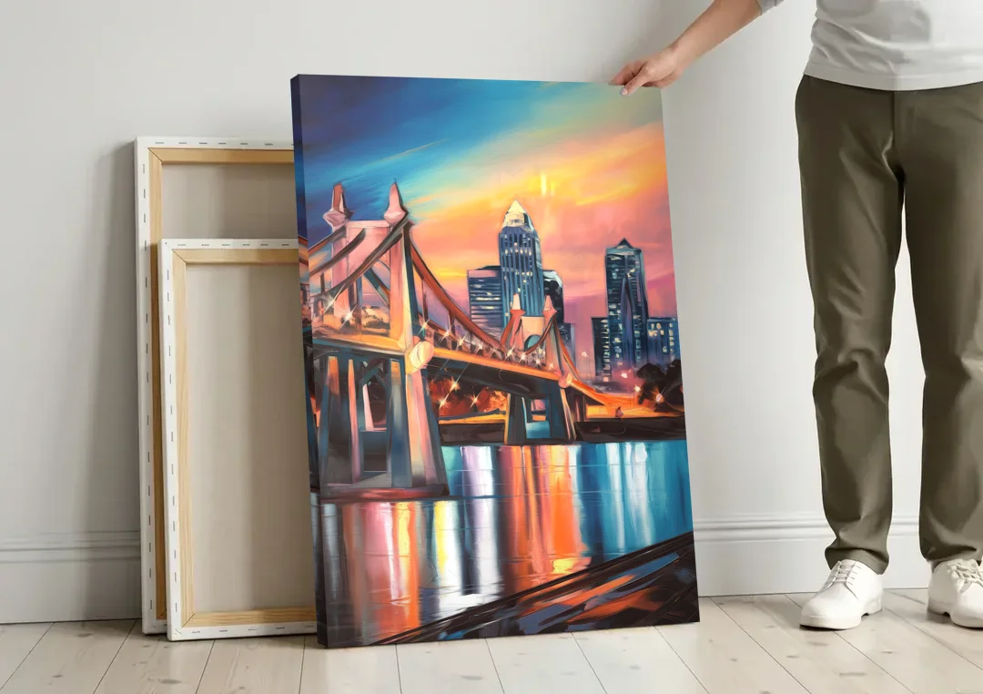 Cincinnati Skyline and Historic Bridges canvas wall art leaning against a wall next to blank canvases