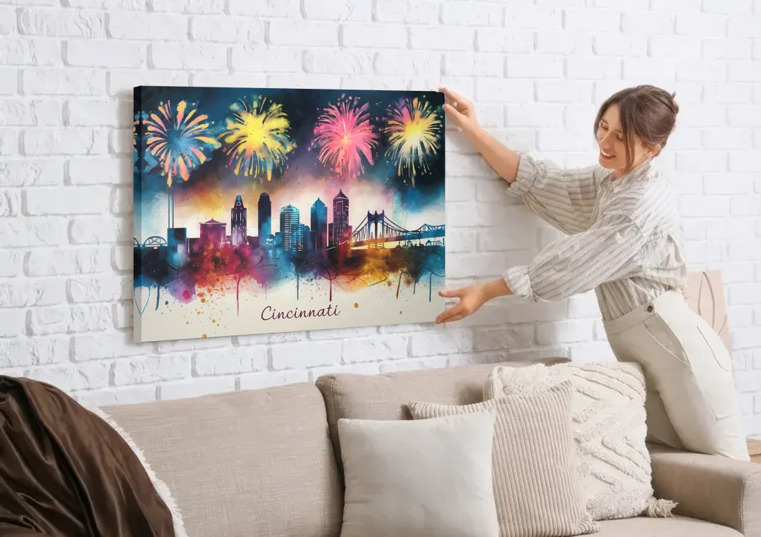 Cincinnati Skyline With Fireworks canvas wall art being hung on a white brick wall above a sofa