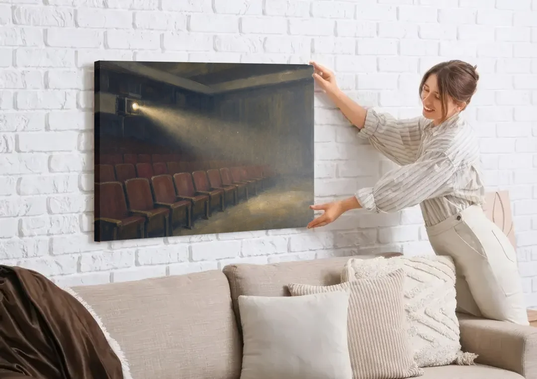 Cinema Wall Art Projector Beam Over Empty Seats canvas wall art being hung on a white brick wall above a sofa